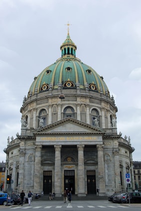 a large building with a dome and columns with Pennsylvania State Capitol in the background