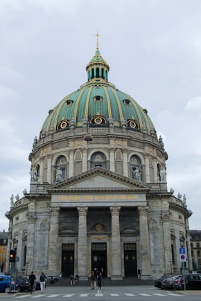 a large building with a dome and columns with Pennsylvania State Capitol in the background