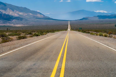 a road with mountains in the background