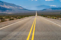 a road with mountains in the background