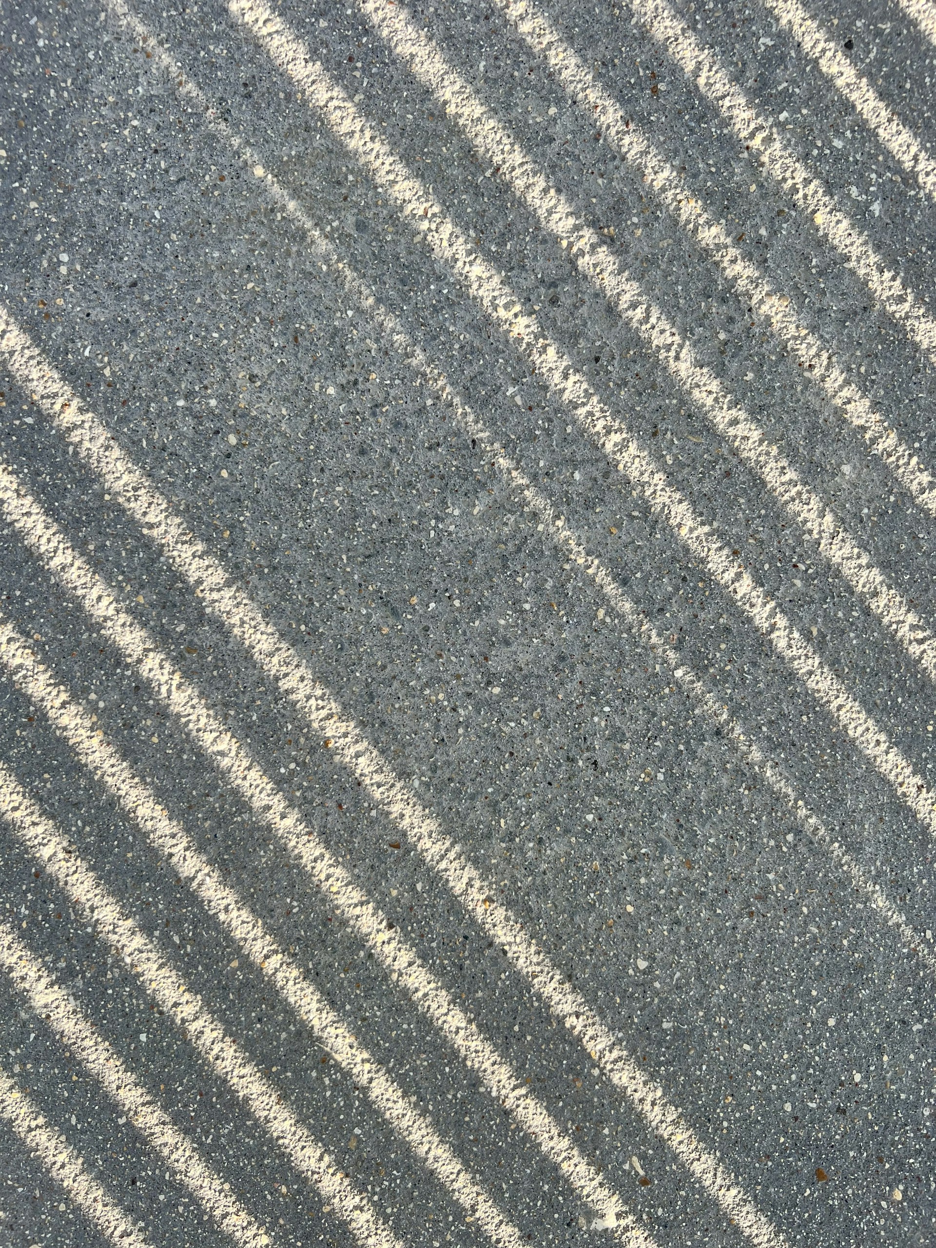 a shadow of a person on a road