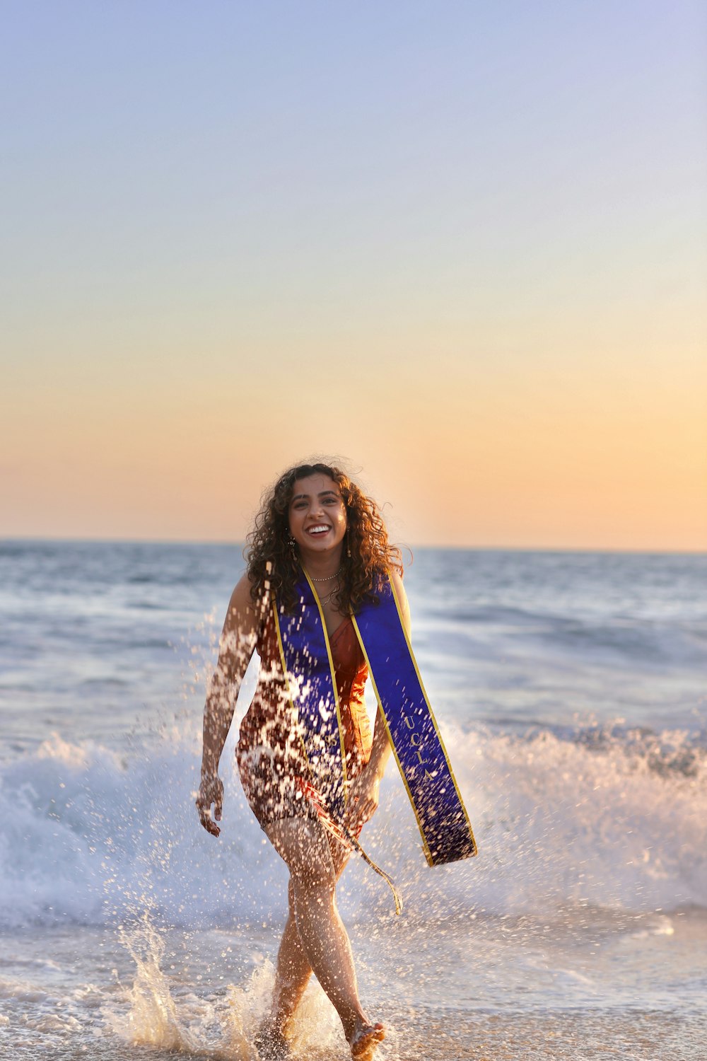 a person carrying a surfboard in the ocean