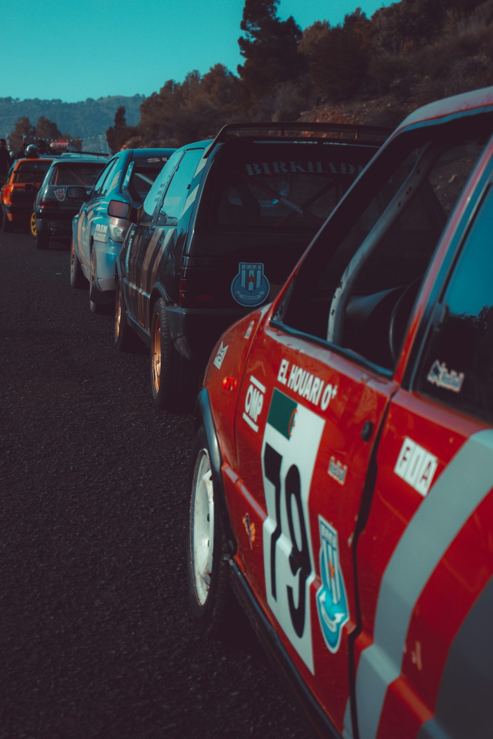 a row of cars parked on a road