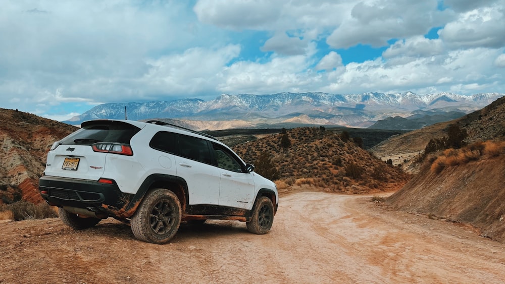 a white car on a dirt road