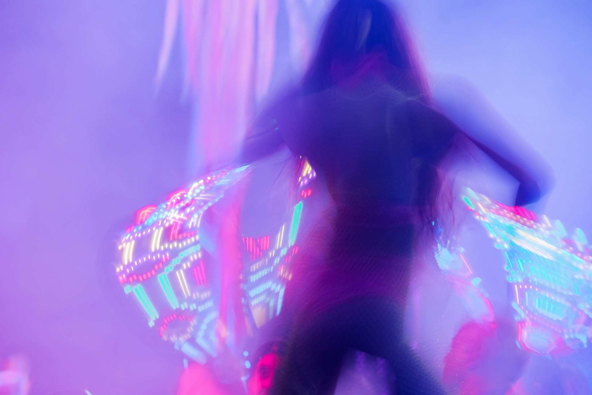 A vibrant, dynamic banner showing a joyful woman over 35 enjoying a lively workshop, with colorful abstract shapes moving in the background.