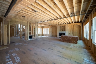 a room with a wood floor and a bench ready for custom home construction