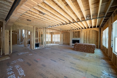 a room with a wood floor and a bench ready for custom home construction