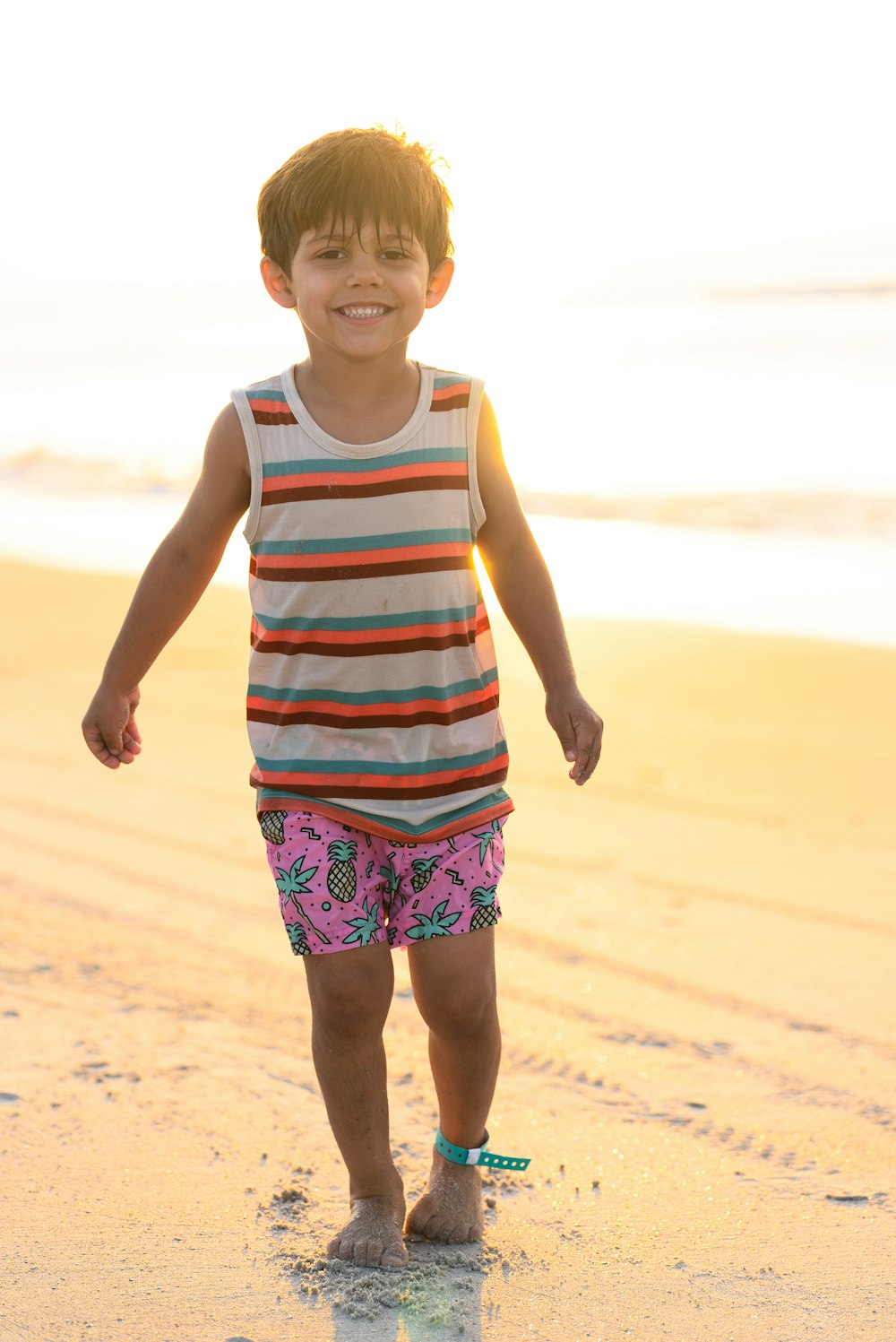 a boy walking on a beach