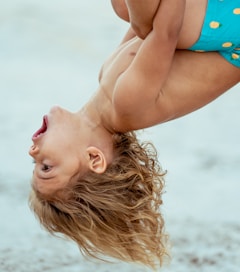 a woman lying on her back on the beach