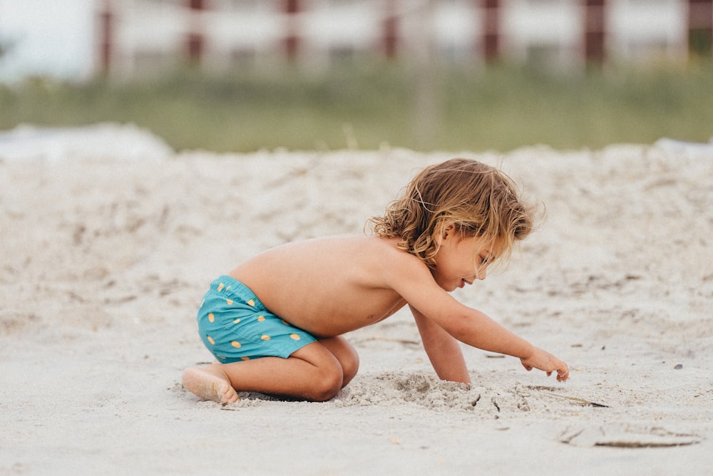 a baby crawling on sand