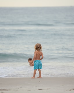 a couple of children on a beach