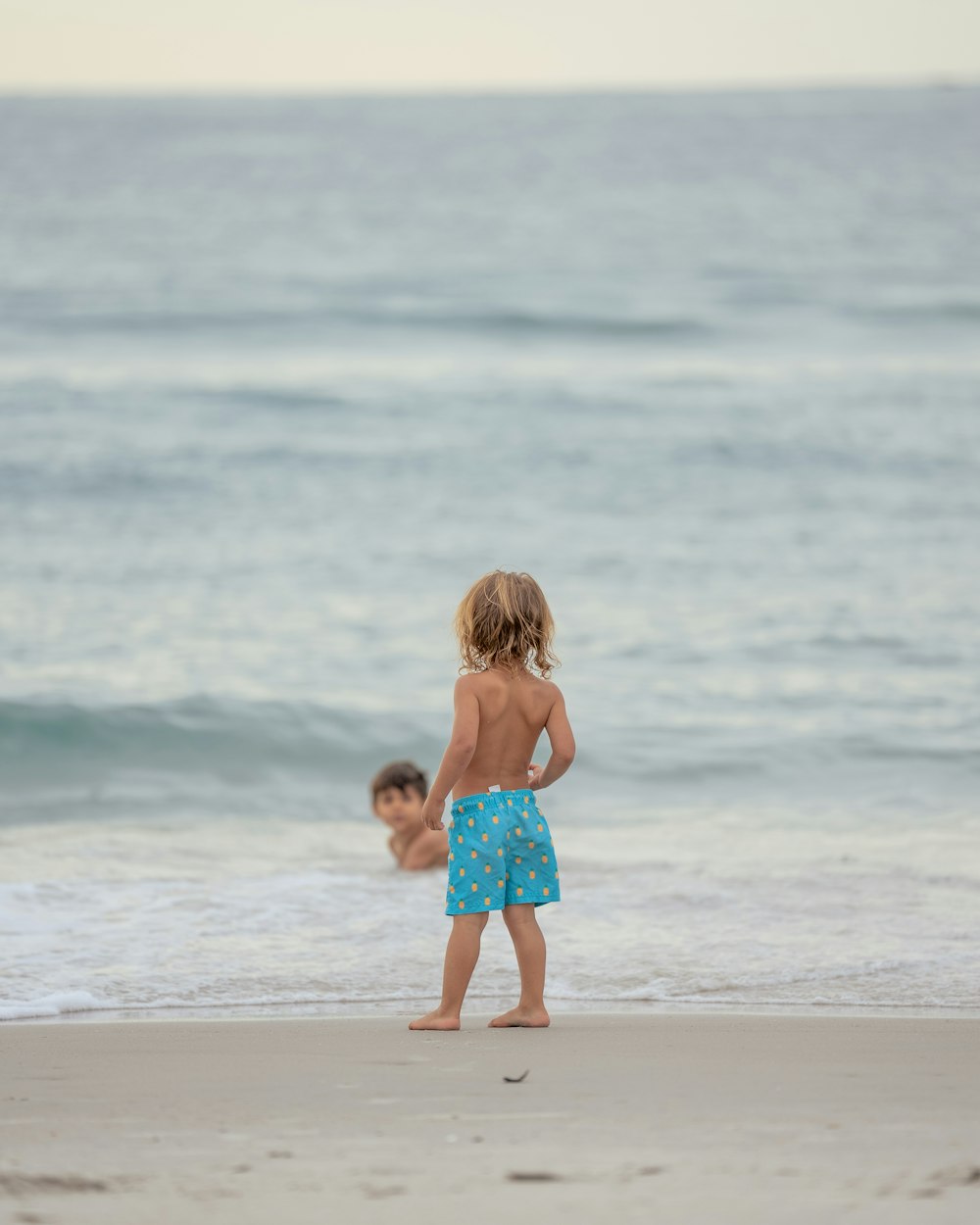 a couple of children on a beach