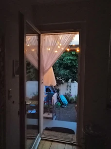 A stylish sliding door opening to a vibrant garden patio, blending indoor and outdoor spaces.