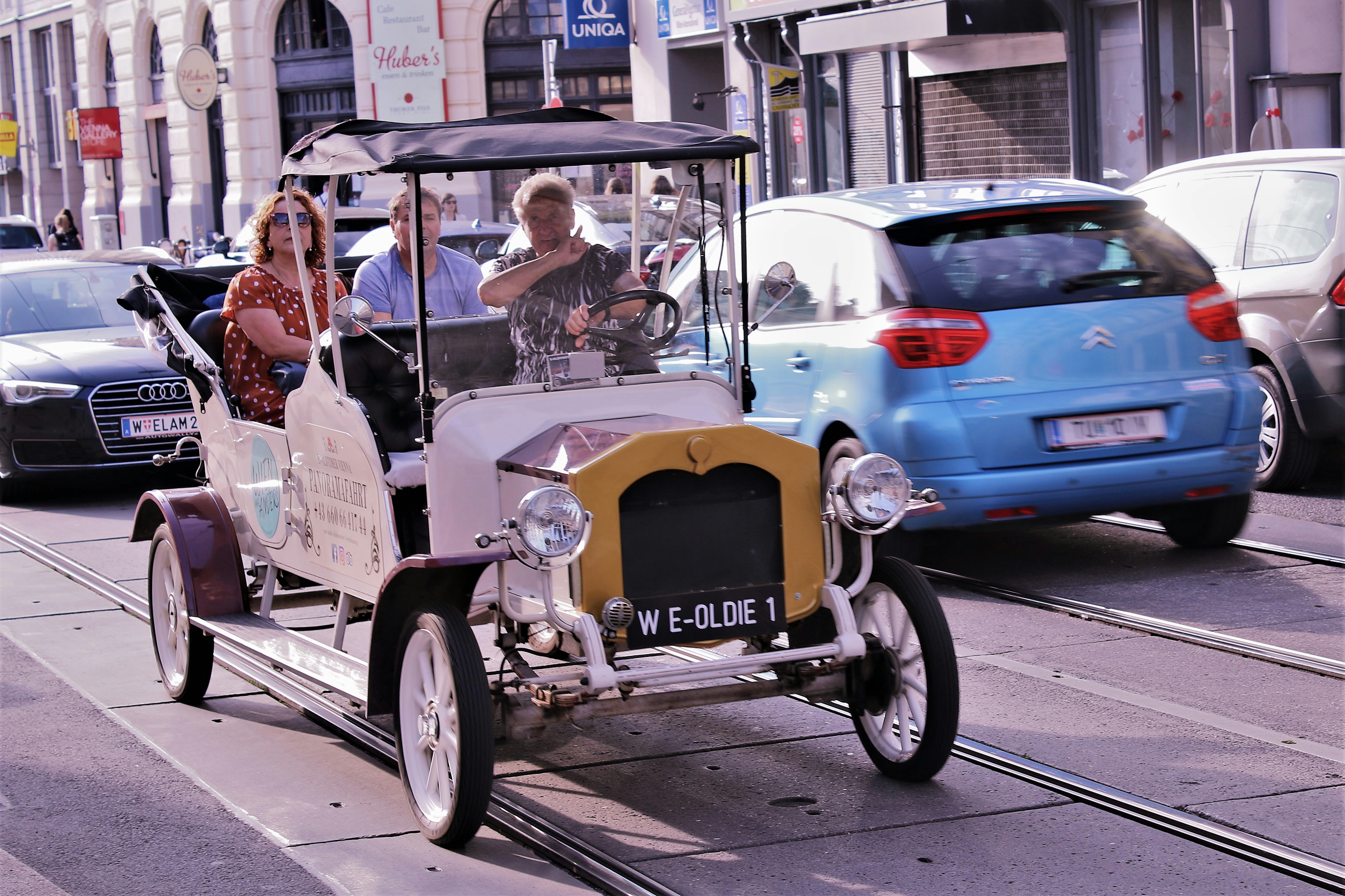 a group of people riding in a small car