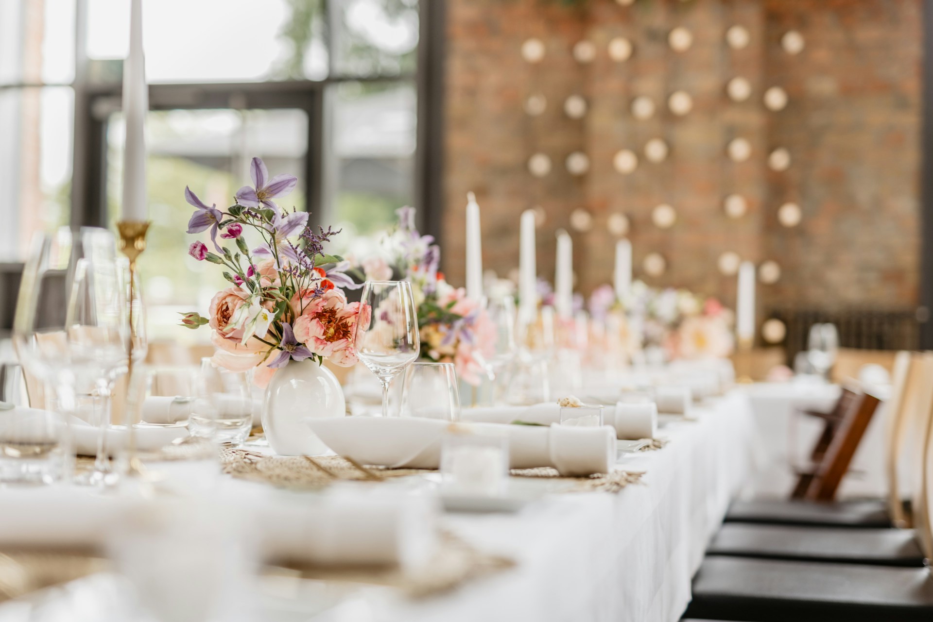 a table with white plates and glasses