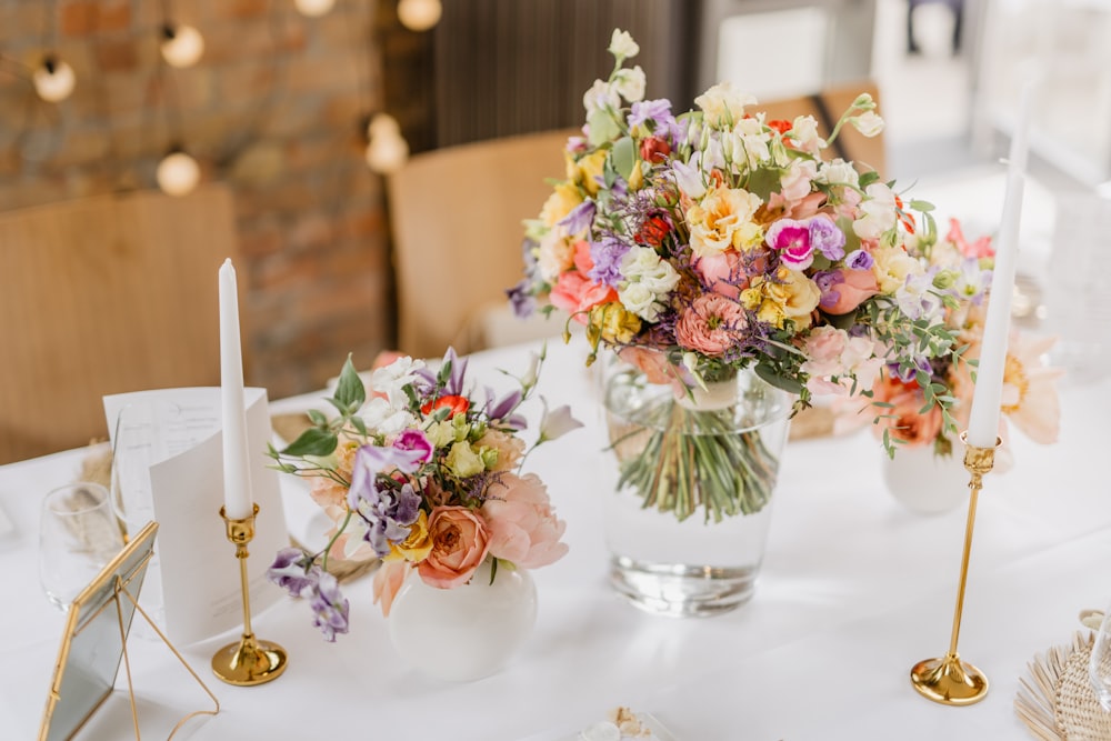 a table with flowers and candles