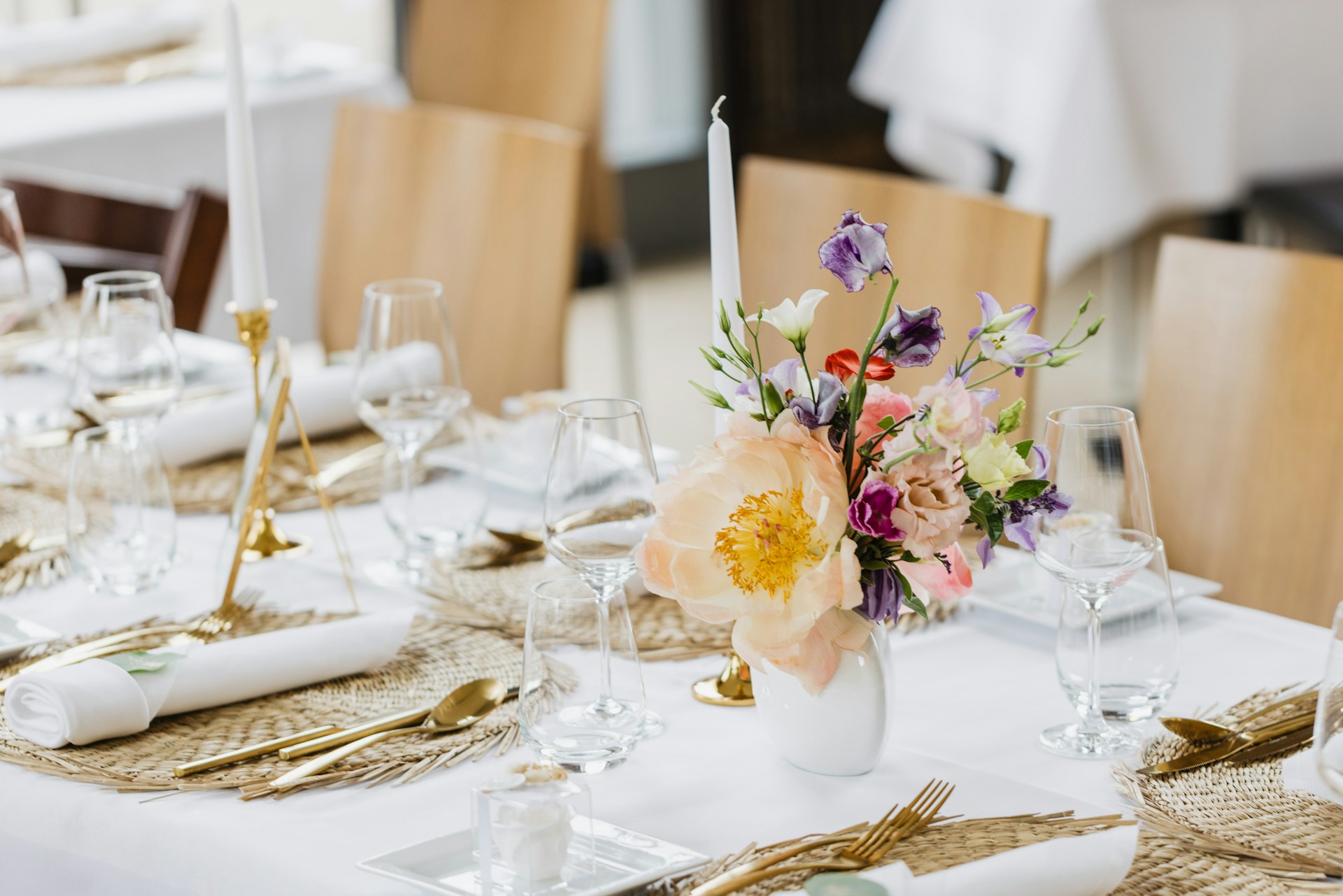 a table with a white tablecloth and flowers