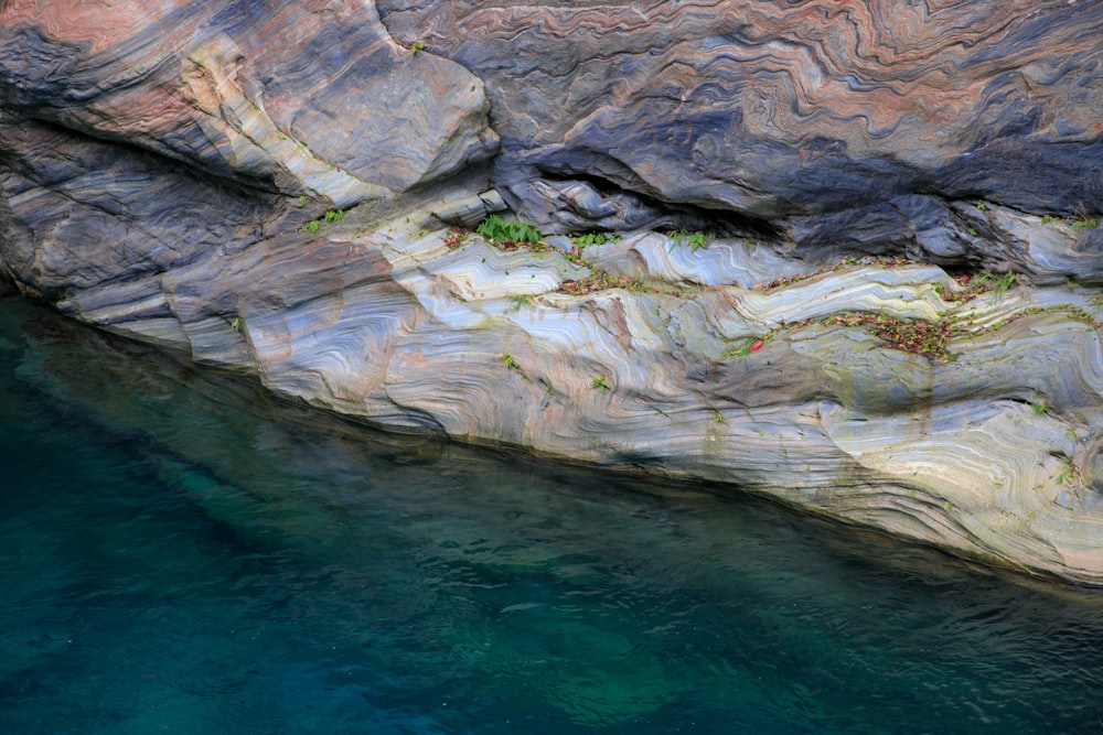 a rocky cliff with water below