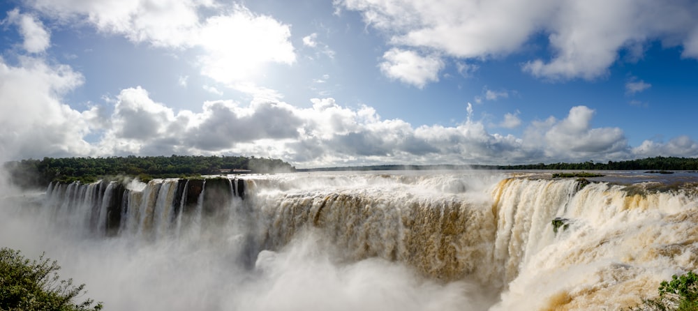 a large waterfall with a blue sky