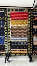 Exhibition of vibrant African textiles displayed in a gallery.