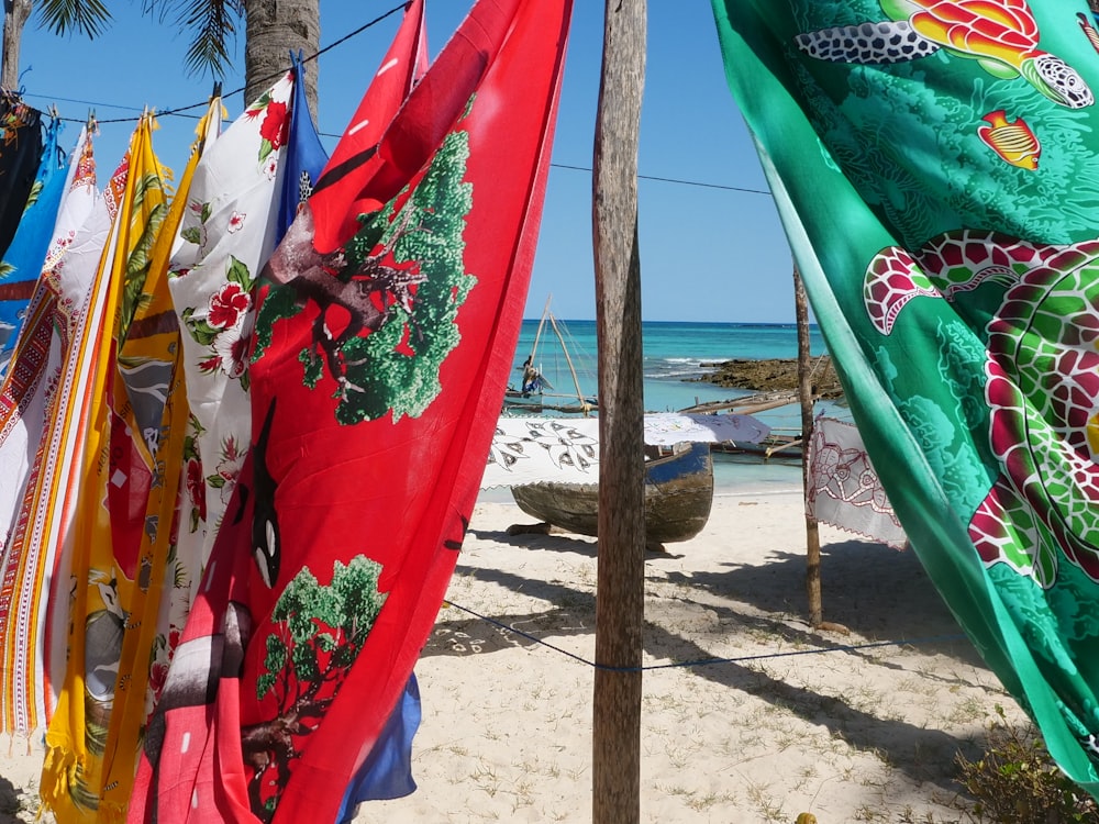 several colorful flags on a beach