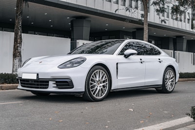 a white car parked in front of a building
