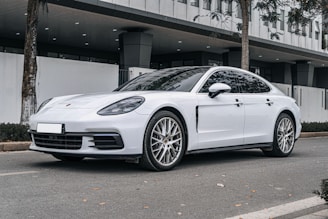 a white car parked in front of a building