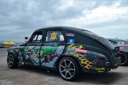 A series of vehicle decals applied to a Calgary local business car parked against a clear blue sky.