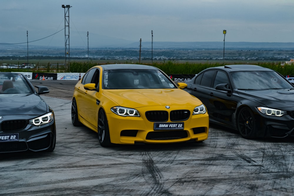 a yellow car parked next to other cars