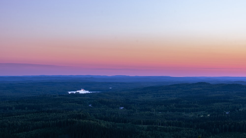 a landscape with a body of water in the distance