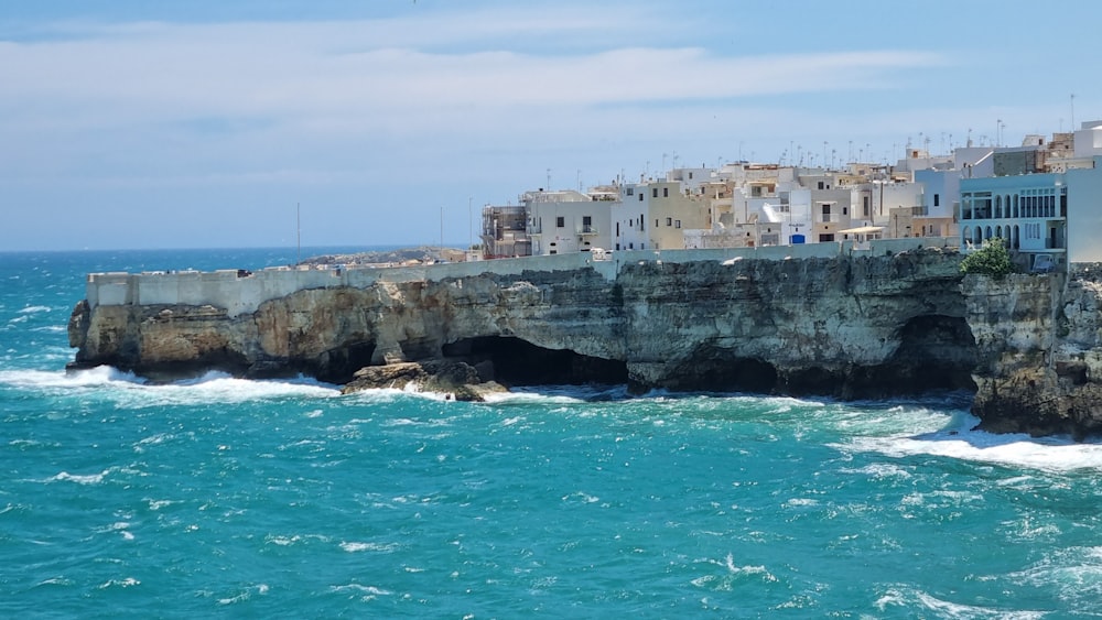 a rocky cliff with buildings on it