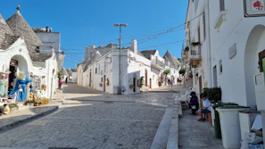 A charming Salento village street lined with whitewashed houses and colorful shutters.