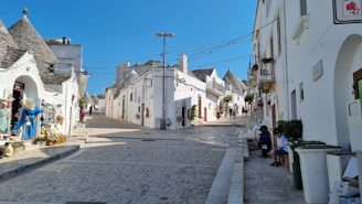 A charming Salento village street lined with whitewashed houses and colorful shutters.