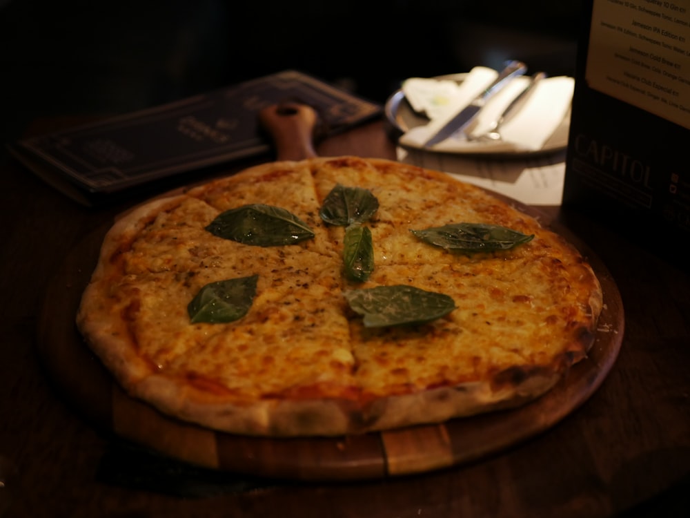a pizza with basil on it
