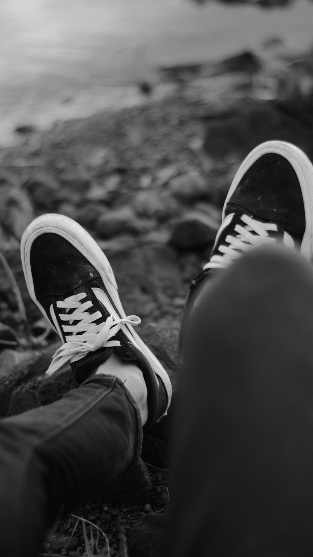 a pair of feet with black shoes