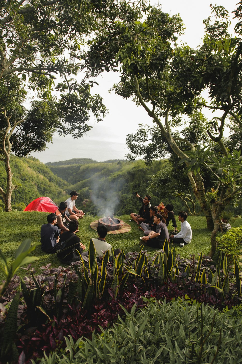 a group of people sitting on a bench in a park