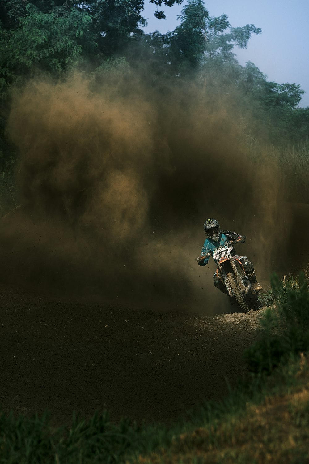 a person riding a motorcycle on a dirt trail