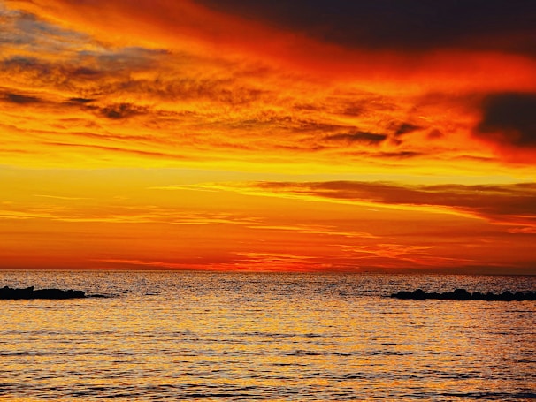 A stunning sunset over the ocean, highlighting the vibrant colors of the sky.