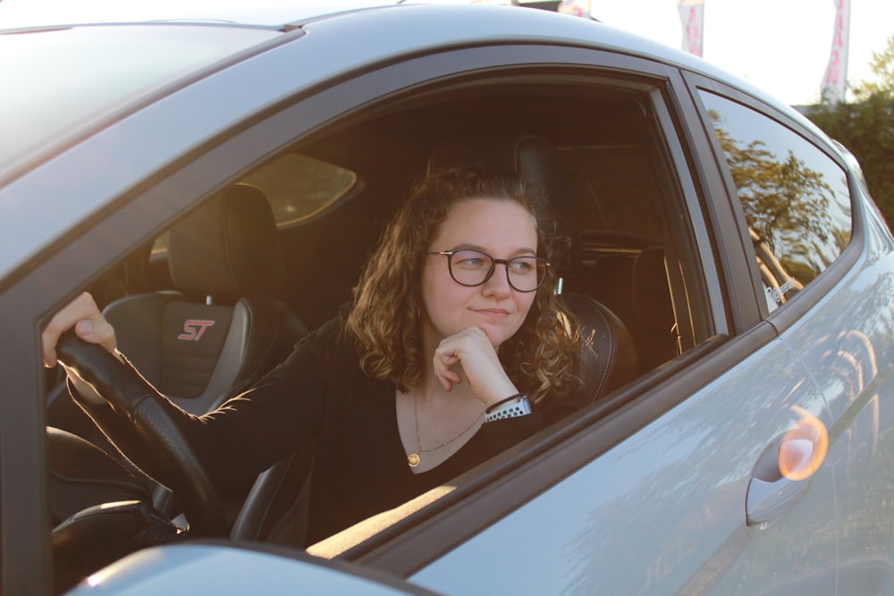 a woman sitting in a car