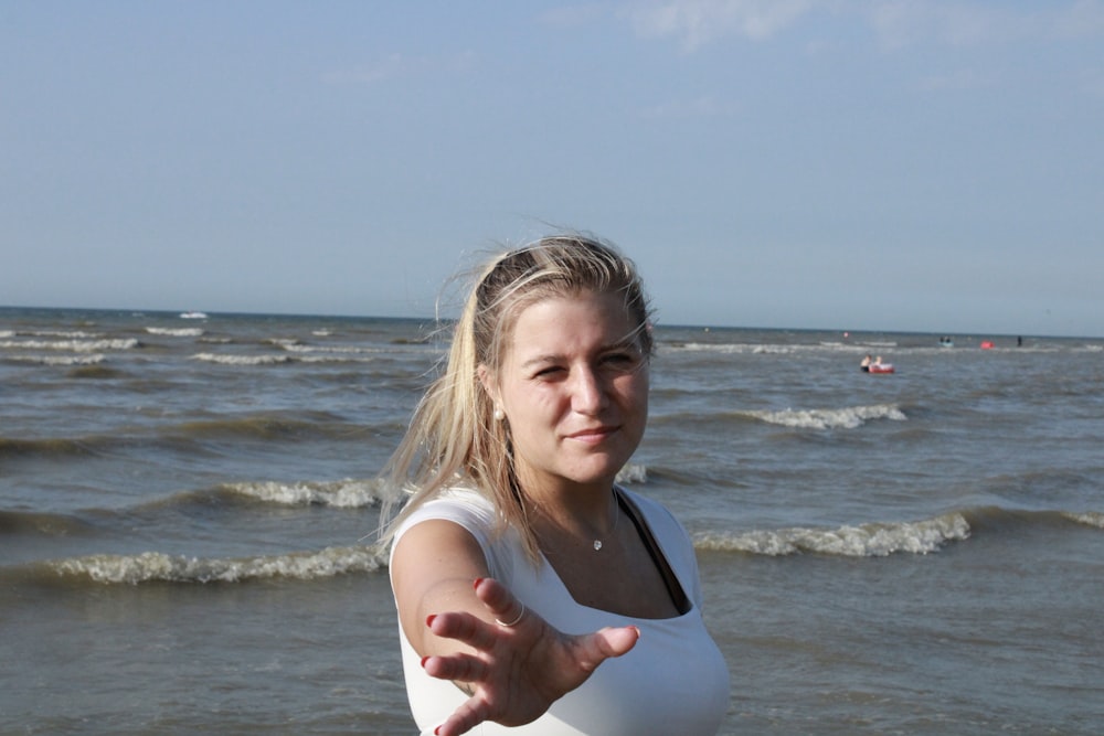 a person with the arms crossed in front of the ocean