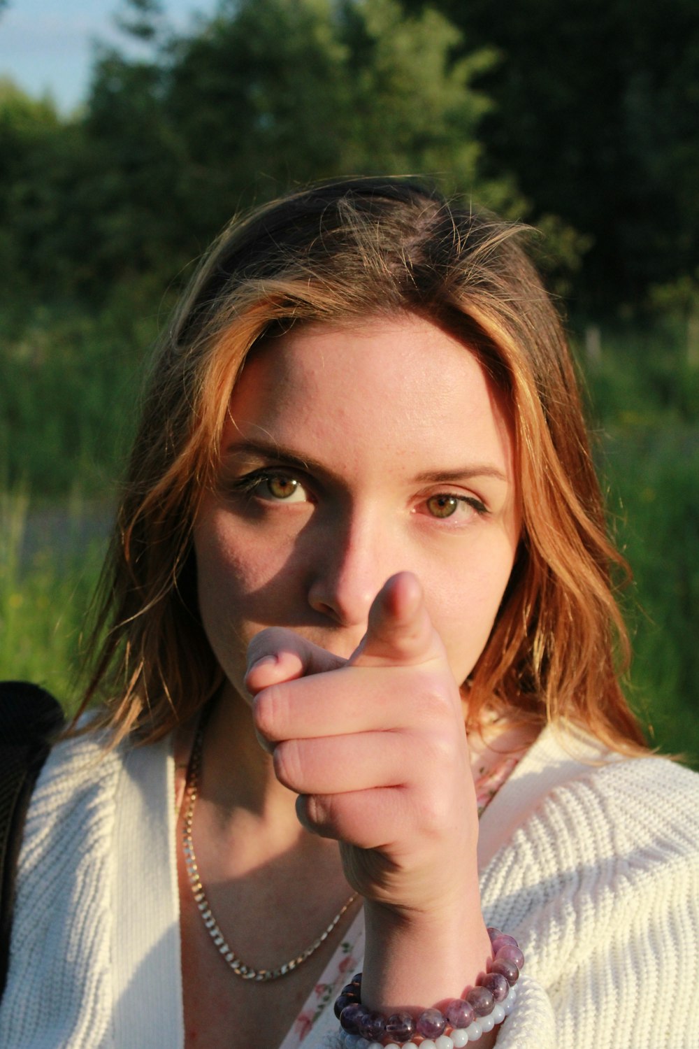 a woman with her hand on her chin