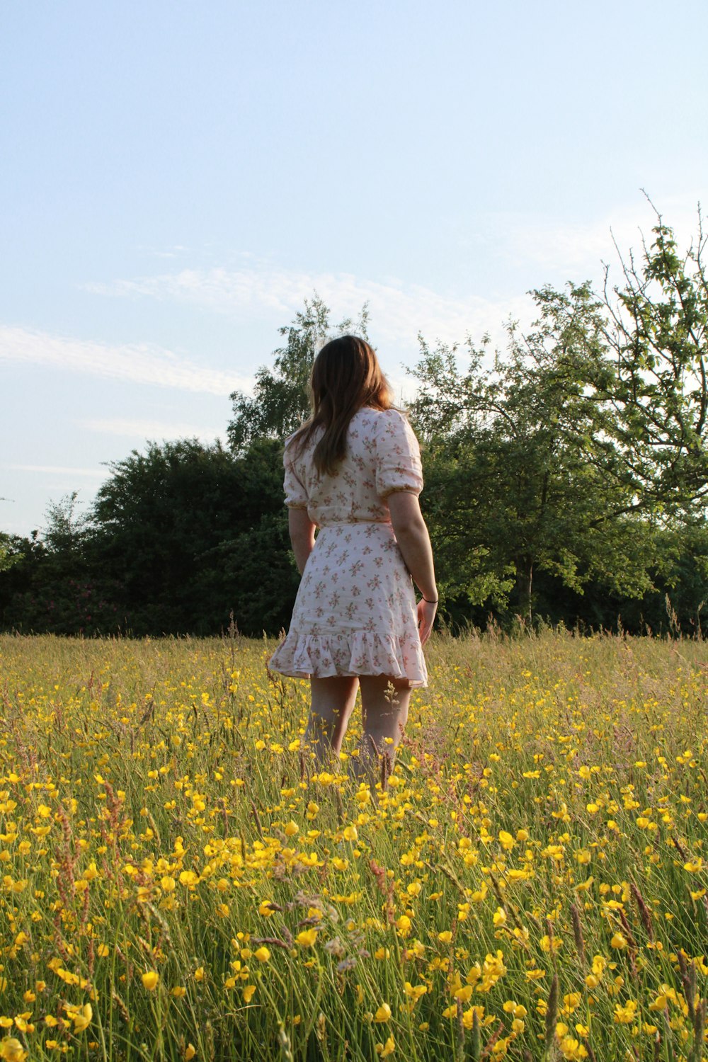 a person standing in a field of flowers