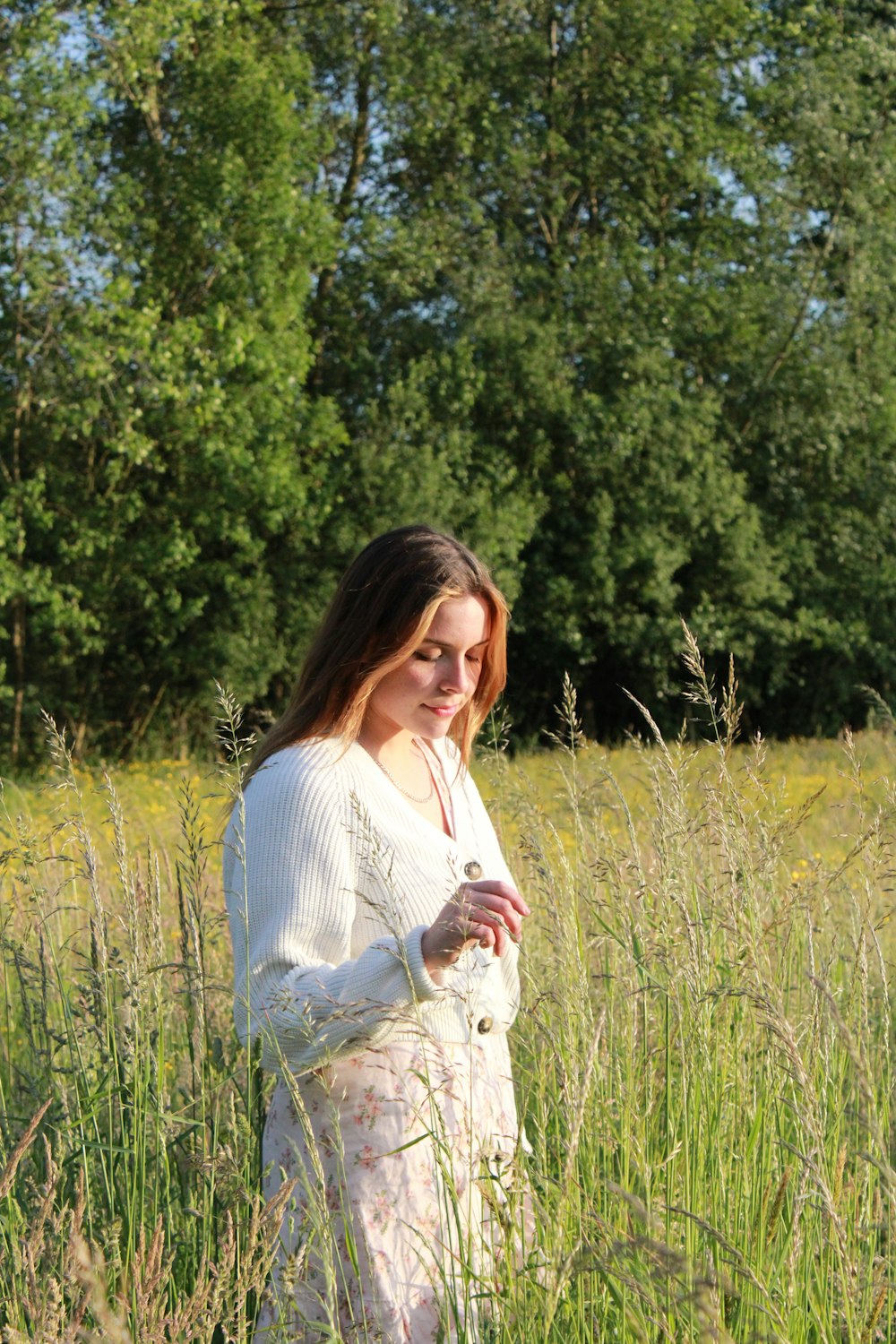 a person holding a cat in a field