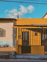 a yellow building with a gate