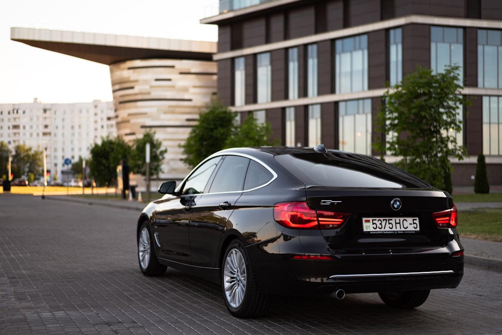 a black car parked in front of a building