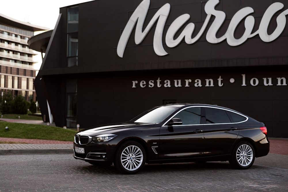 a black car parked in front of a building