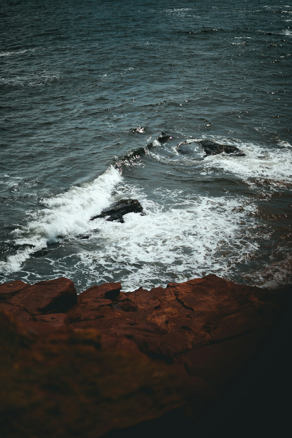 a rocky beach with waves crashing