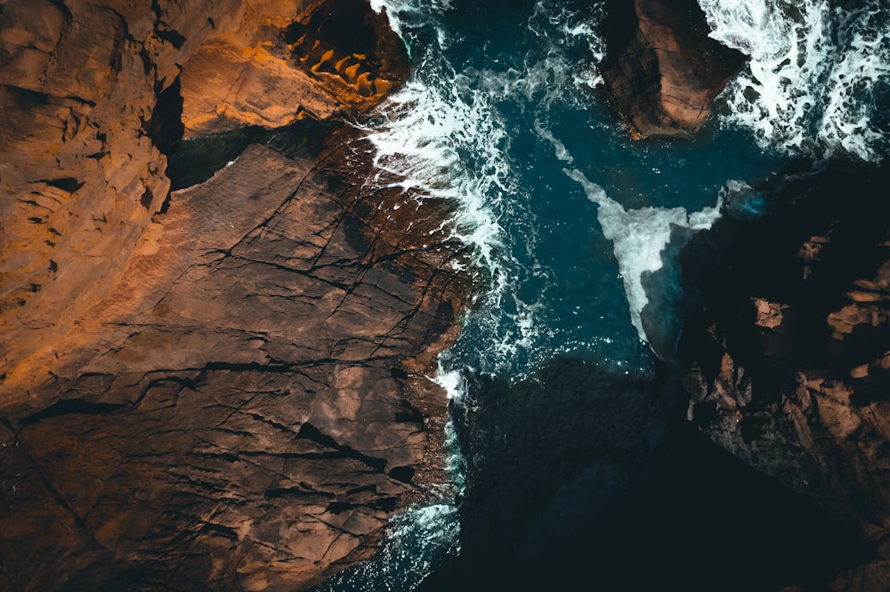 a rocky cliff with a waterfall