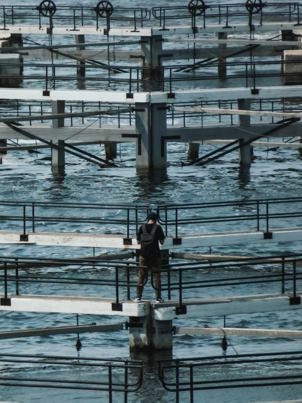 a person standing on a bridge