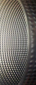 Vibrating drums gently polishing metal components in a batch.